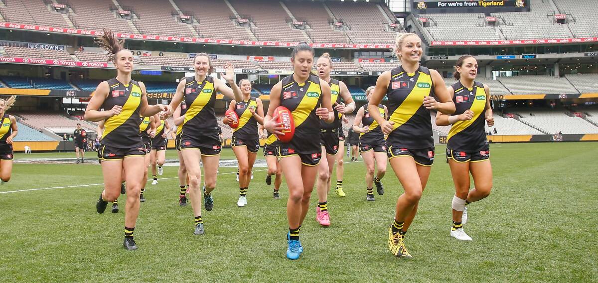 The Richmond AFLW side runs on to the MCG for the first time for a practice game earlier this month ... (l to r) Gabby Seymour, Bec Miller, Emelia Yassir, Sarah Hosking and Mon Conti. Photo: Wayne Ludbey, Richmond Football Club 