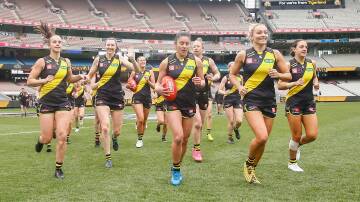 The Richmond AFLW side runs on to the MCG for the first time for a practice game earlier this month ... (l to r) Gabby Seymour, Bec Miller, Emelia Yassir, Sarah Hosking and Mon Conti. Photo: Wayne Ludbey, Richmond Football Club 