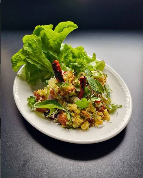 Jeow's Nam Khao, a crispy rice salad flavoured with freshly grated coconut, sour pork, herbs and spices