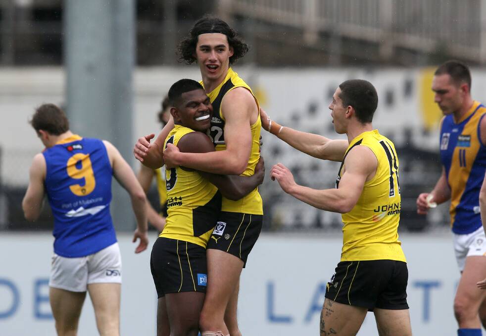 Sampson Ryan with Maurice Rioli Jnr ... Ryan impressed with solid ruckwork, but also troubled the scorers, kicking three goals. Photo: Wayne Ludbey, Richmond Football Club