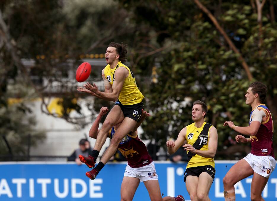 First year Tiger player Josh Gibcus leaps to take a chest mark in the VFL match against the Lions. Photo: Wayne Ludbey, Richmond Football Club 