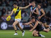 Richmnd's Trent Cotchin (l) will face match video scrutiny for a heavy tackle. (Matt Turner/AAP PHOTOS)
