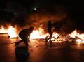 Palestinian demonstrators burn tyres to protest against Israeli air strikes in Gaza. (EPA PHOTO)