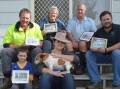 Looking over 100 years of history is third generation dairy farmer Ian Alley with his wife Leanne, son Clayton who sits with his daughter Charlotte, older brother Anthony who is with his son Lachlan, wife Leanne and daughter Gabby. Photo: DANIELLE BUCKLEY